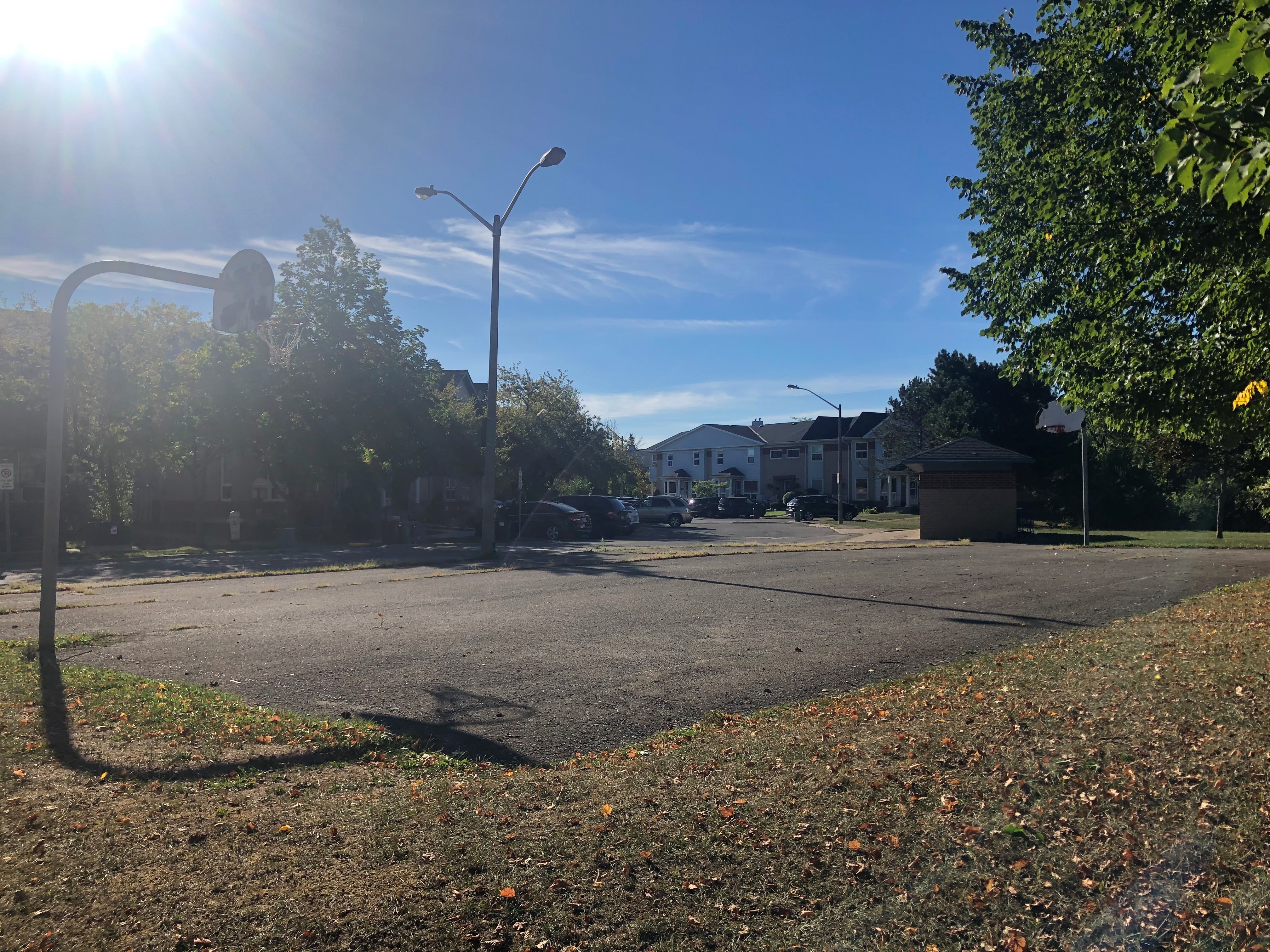 Basketball court with two hoops and a street light